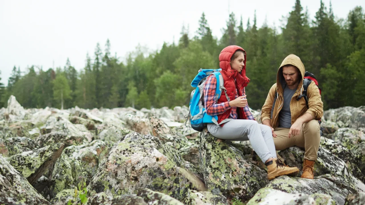travelers siting on big stones