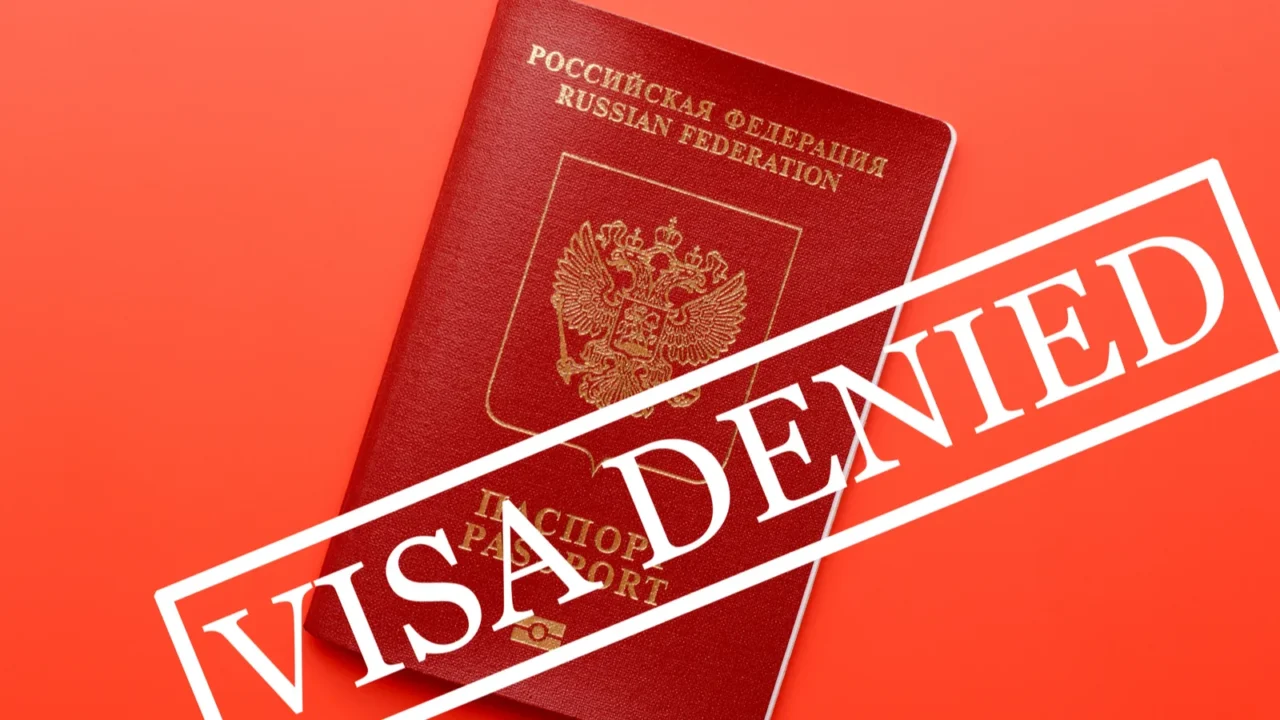 traveling passport on top of red surface with stamp saying