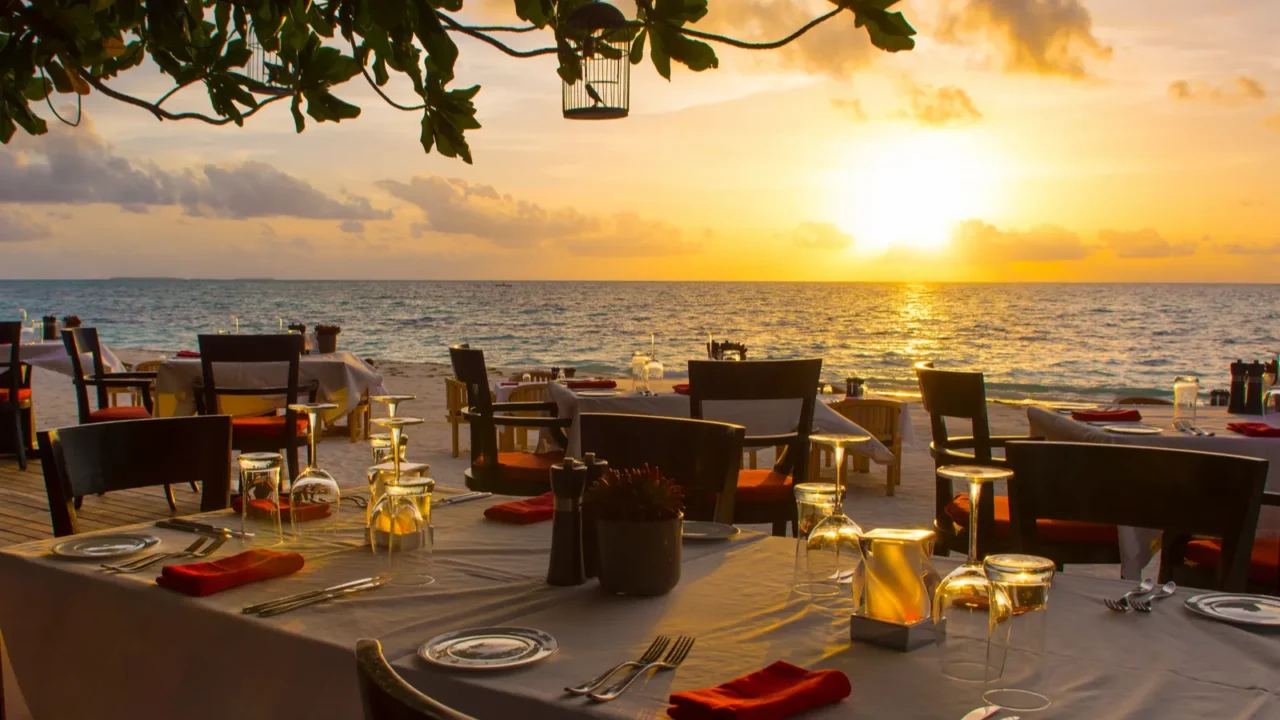 tropical restaurant on the sandy beach landscape of beautiful sunset