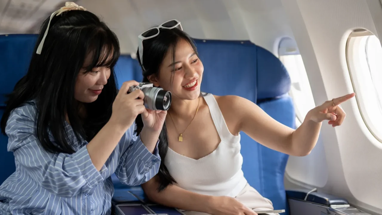 two cheerful young asian female friends are enjoying talking and