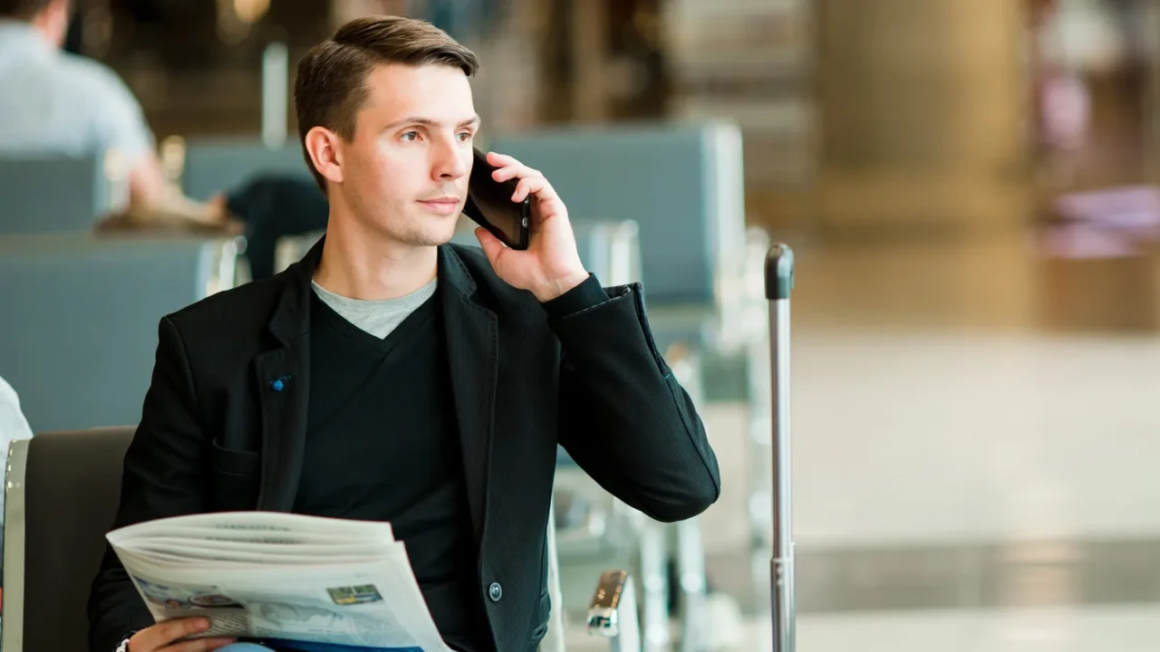 urban business man talking on smart phone traveling inside in