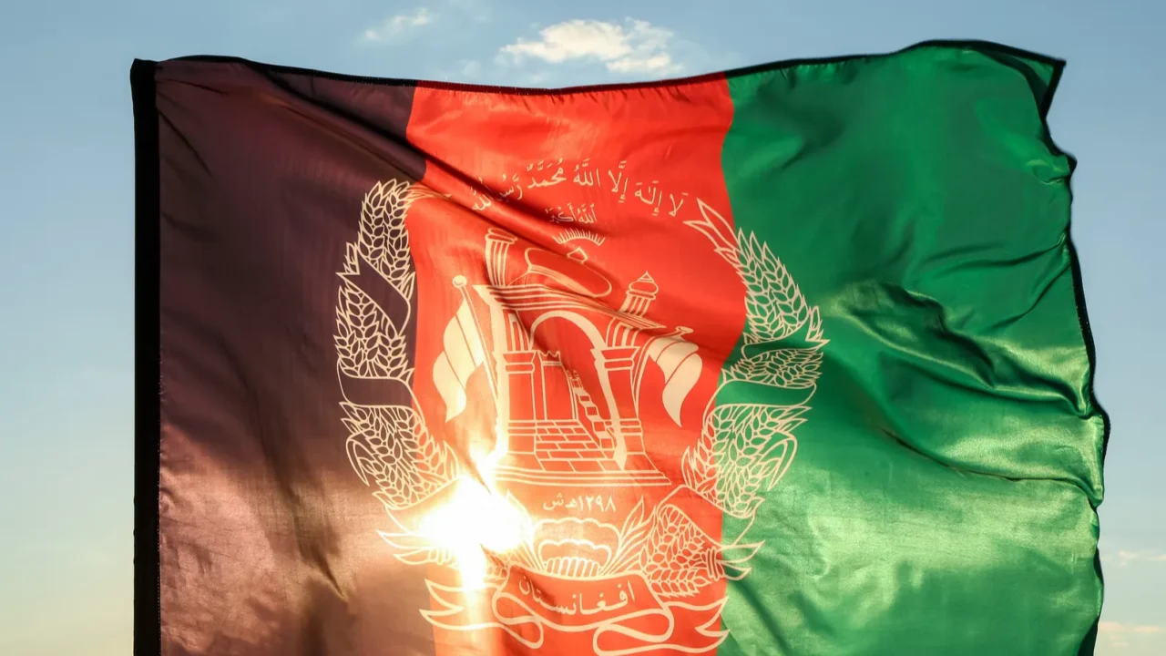 waving afghanistan flag near river
