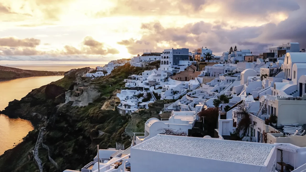 white houses on greek island near sea in evening