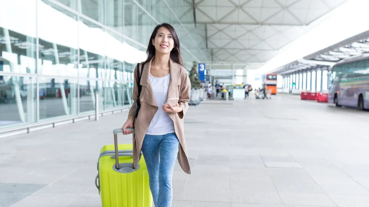woman go travel with cellphone and luggage