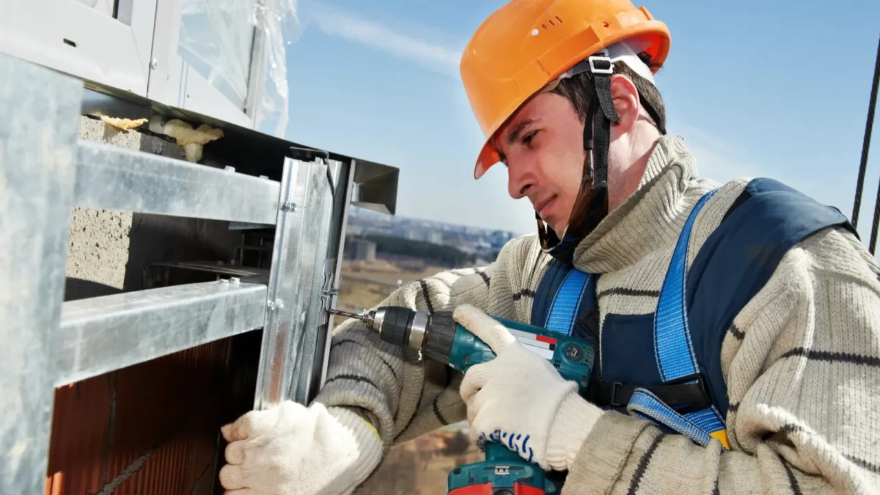 worker builders at facade tile installation