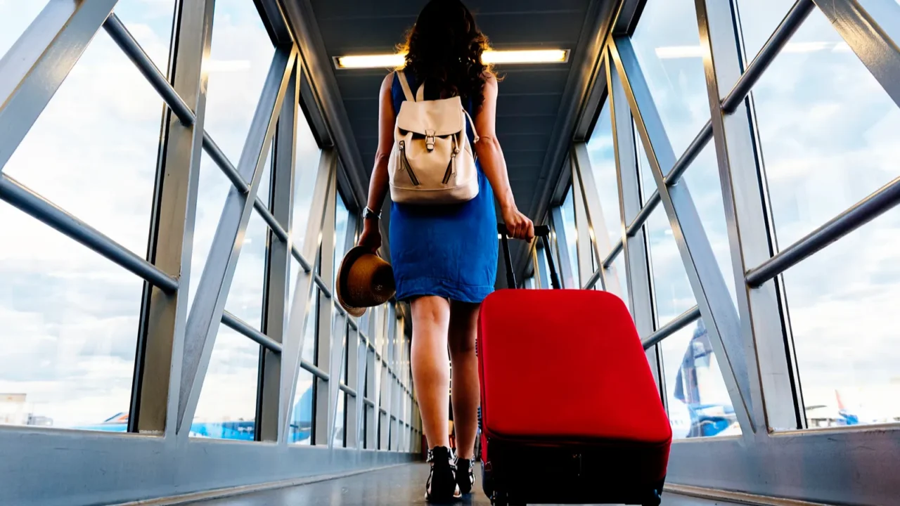 young girl traveler walking with carrying hold suitcase in the