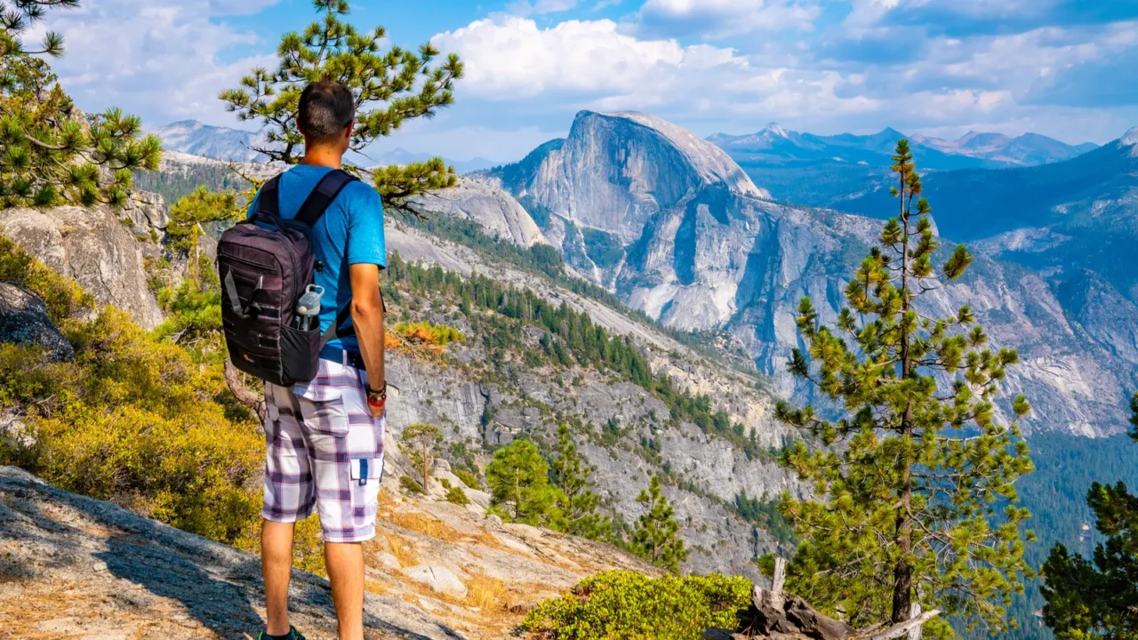 young man hiking in the yosemite national park exploring the