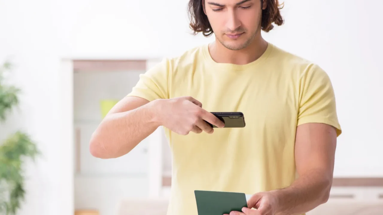 young man holding passport preparing for summer trip