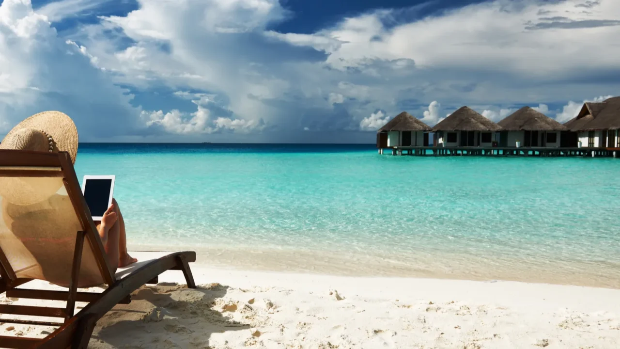 young woman with tablet pc at the beach