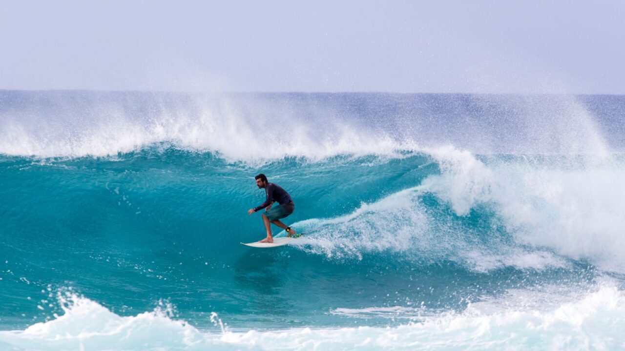 A surfer riding barrels of the Banzai Pipeline, a very popular pro-surf spot at the Northshore region of Oahu.