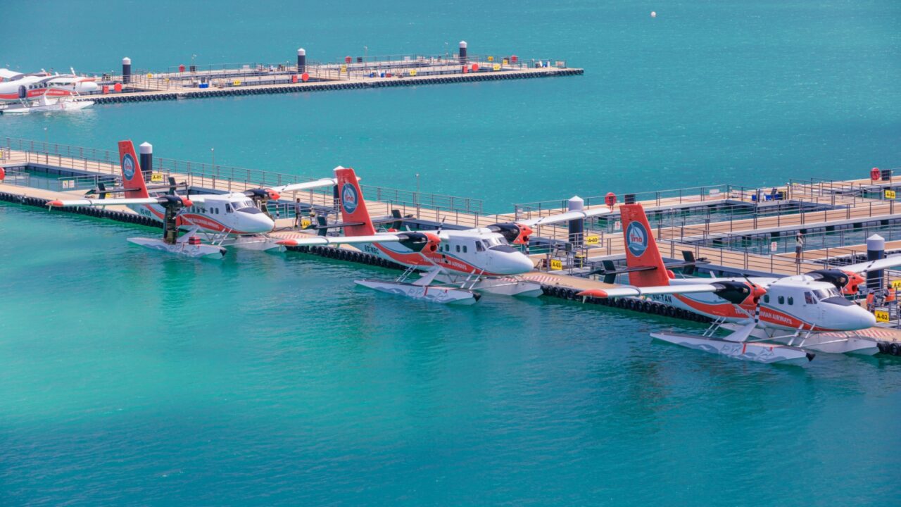 Maldives. Seaplane parking next to new floating dock in calm blue sea. Luxury travel transportation, exotic tourism. Taxing Trans Maldivian Airways Twin Otter seaplanes at Male airport (MLE) 15.03.23
