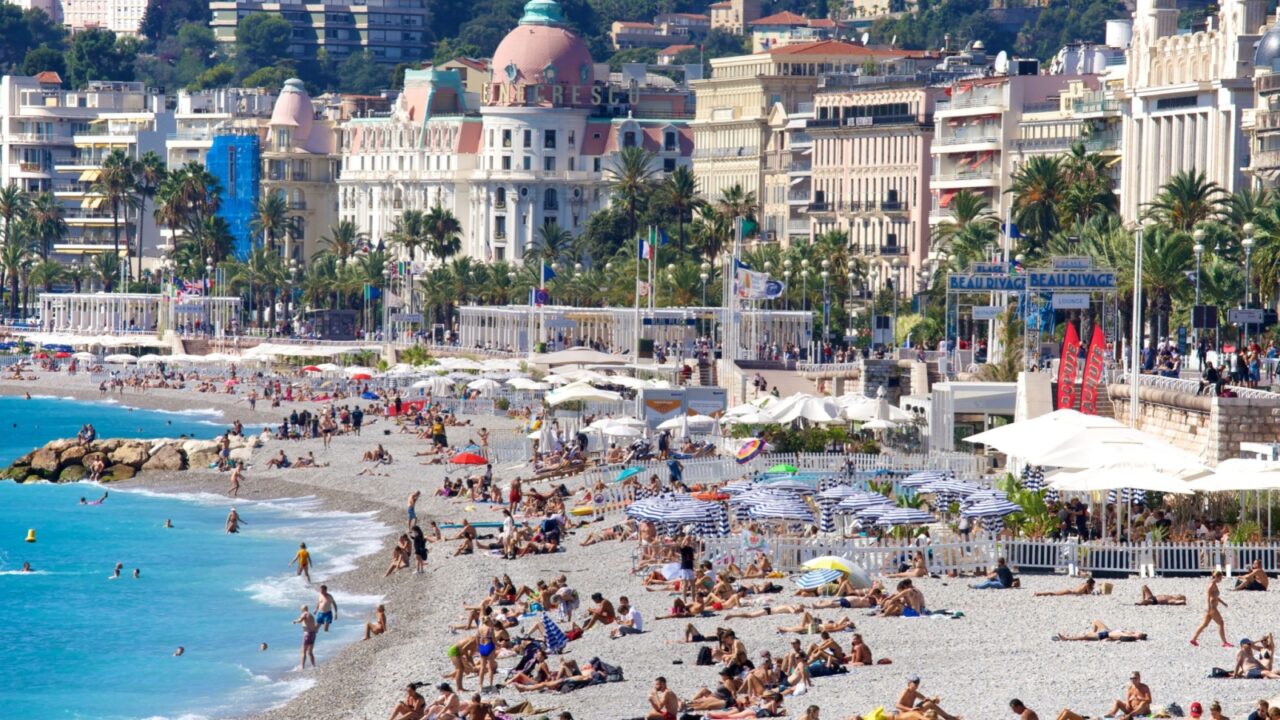 Nice, France - September 21, 2021: The long pebble Mediterranean shoreline in Nice, flanked by the historic Promenade des Anglais, is one of the most visited and iconic beaches on the French Riviera.