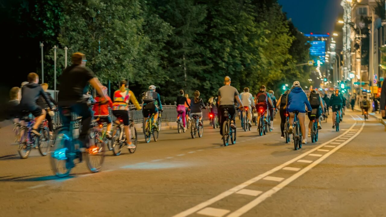 Nighttime bike ride through city street with cyclists