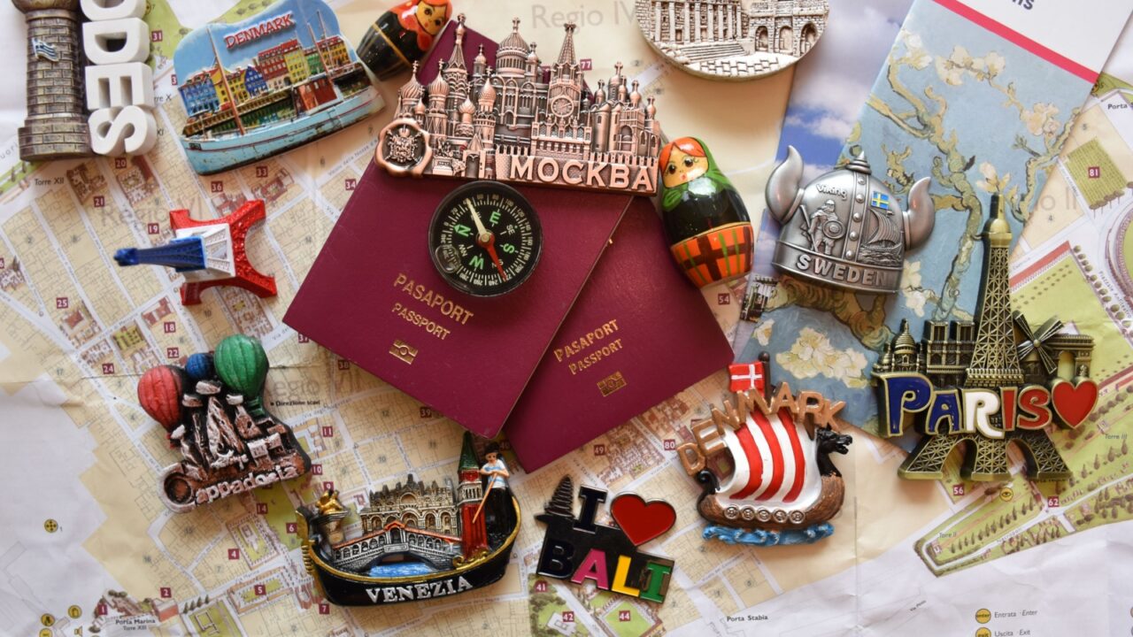 Holiday excitement lots of beautiful memories and colorful souvenirs from the vacation (passports stamps and fridge magnets)