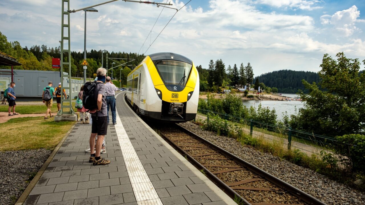 Schluchsee, Baden-Württemberg, Germany - July 28 2020 : tourists with backpack waiting on the platform while the regional train from bwegt enters station