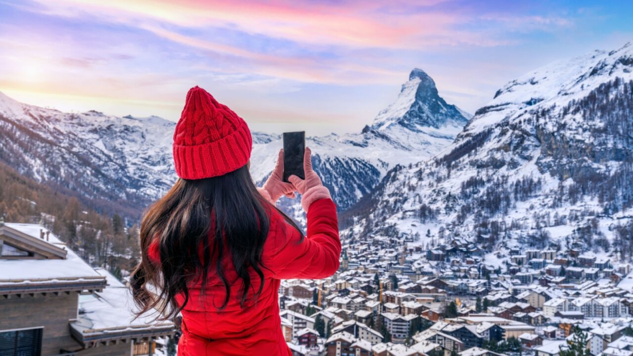 Tourist taking photo at Matterhorn and swiss alps in Zermatt, Switzerland.