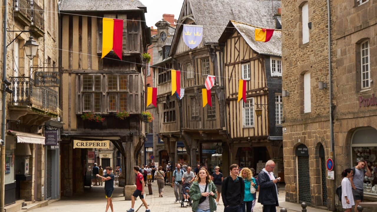 Dinan, France - July 30, 2018 - well-kept half-timbered houses and cobblestone streets of the old town surrounded by walls create an impressive and casual harmony
