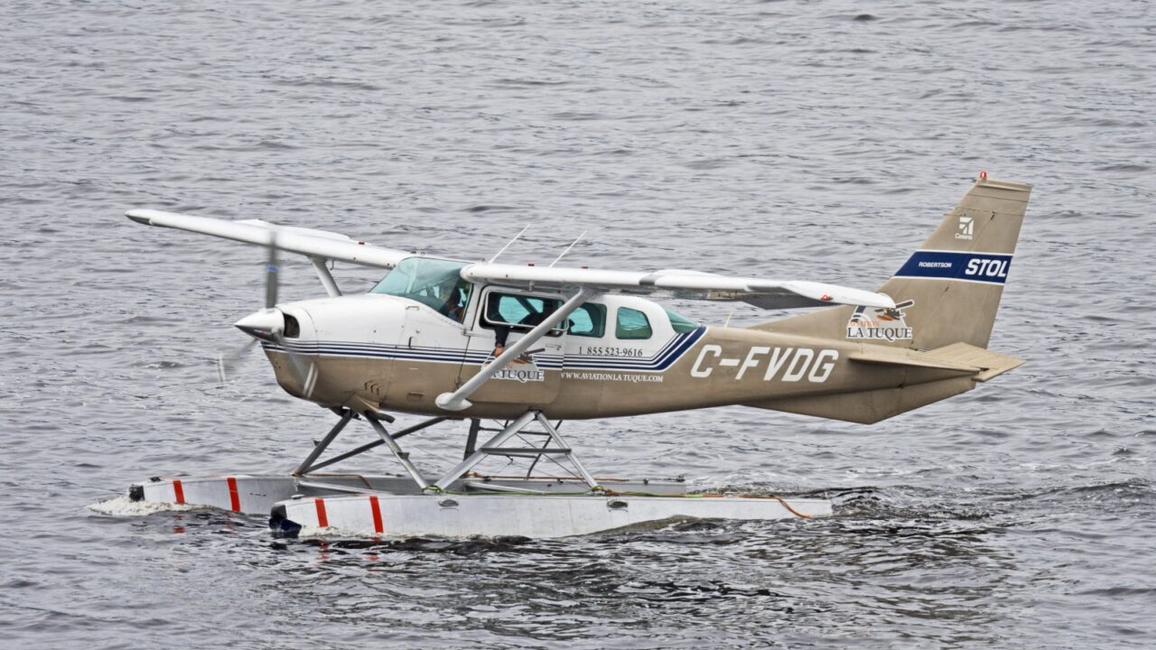 Saguenay, Canada - August 26 2022: a float plane taxiing on the fjord just off Saguenay.