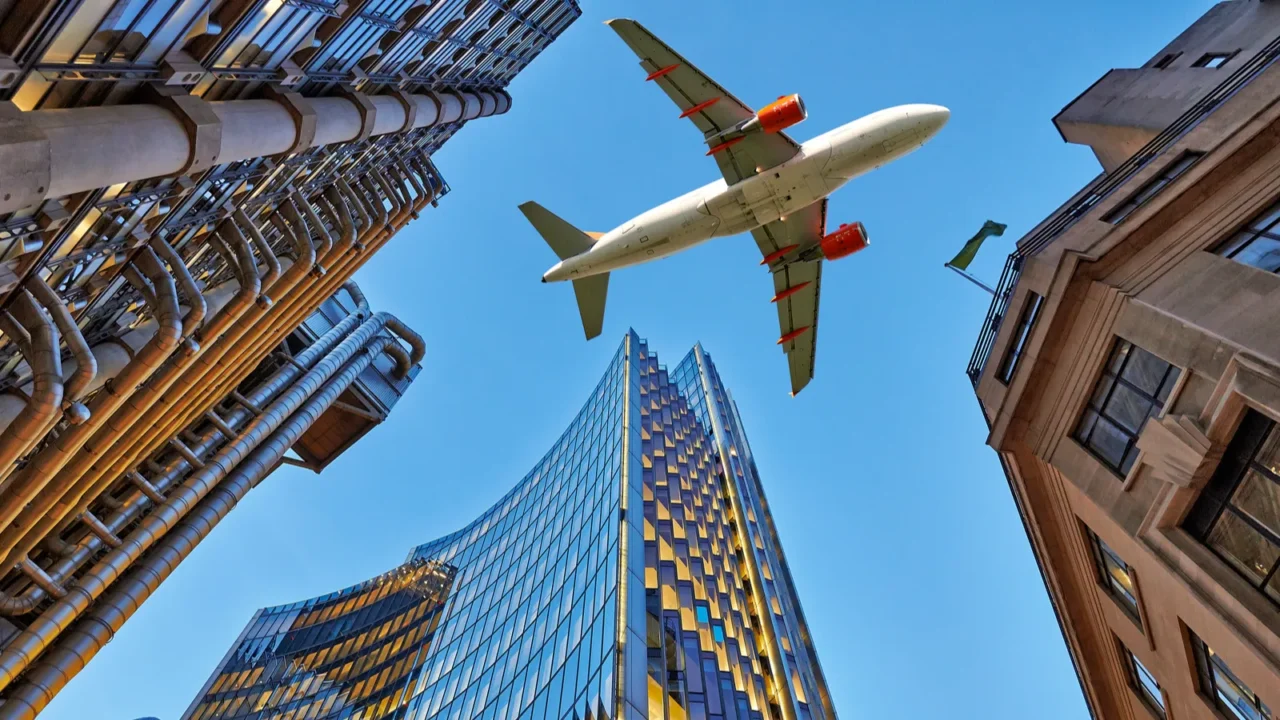 a jet plane flying over the city