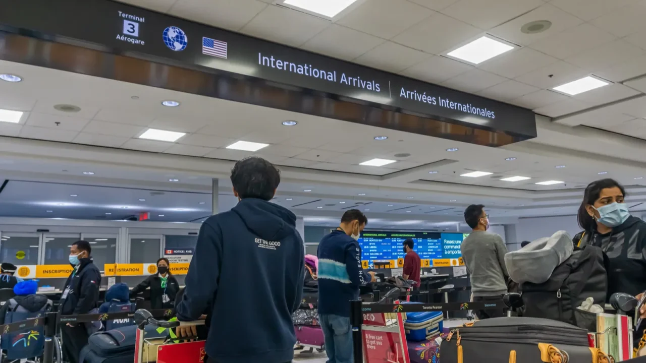 airline arriving passengers waiting in line for their mandatory covid