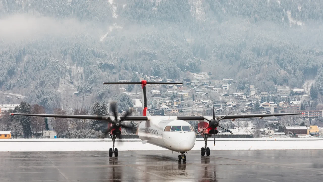 airplane starting engines with snow winter background small regional