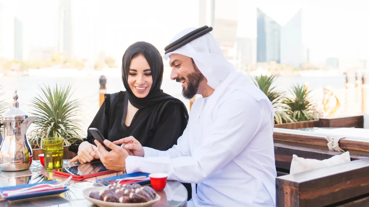 arabian couple with traditional emirates dress dating outdoors  happy