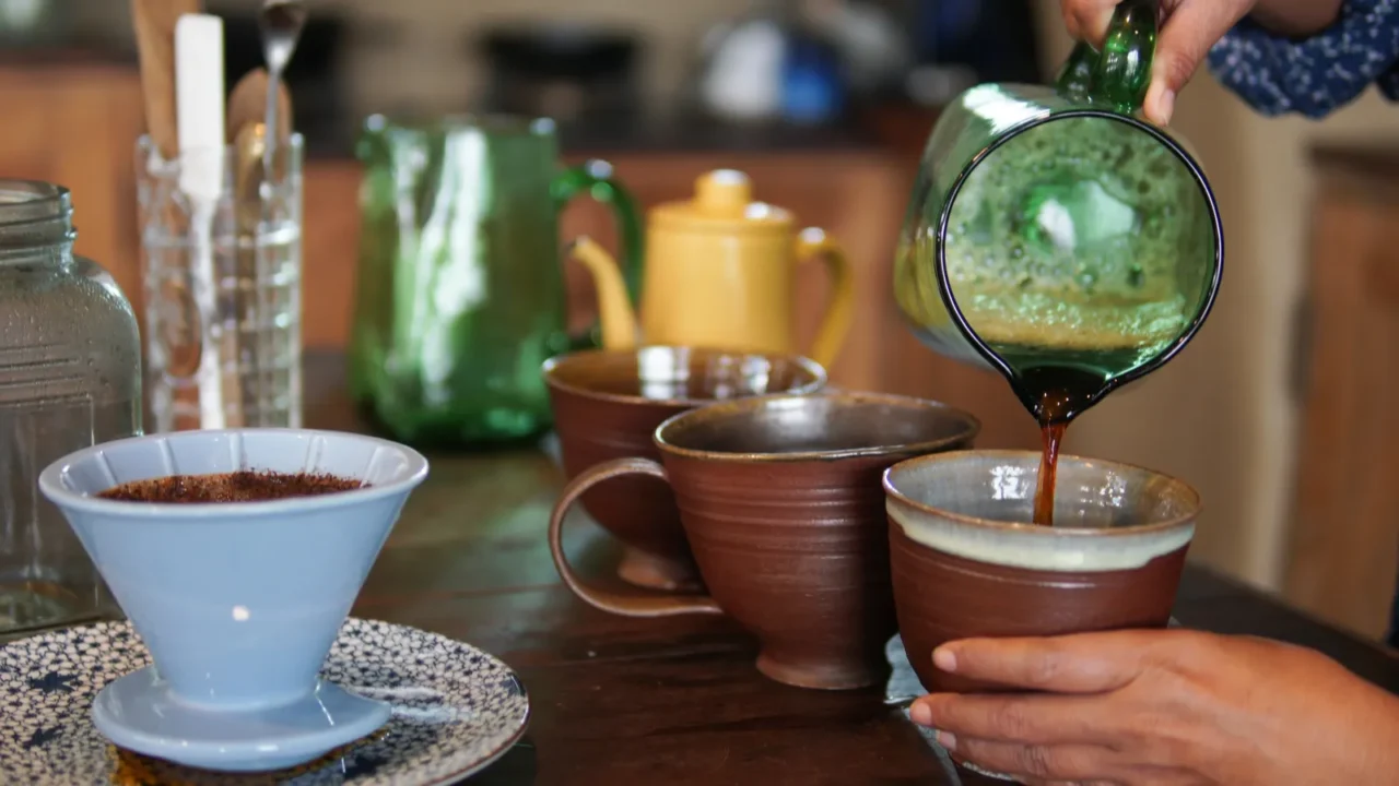 barista preparing brewing coffee with coffee maker and drip kettle