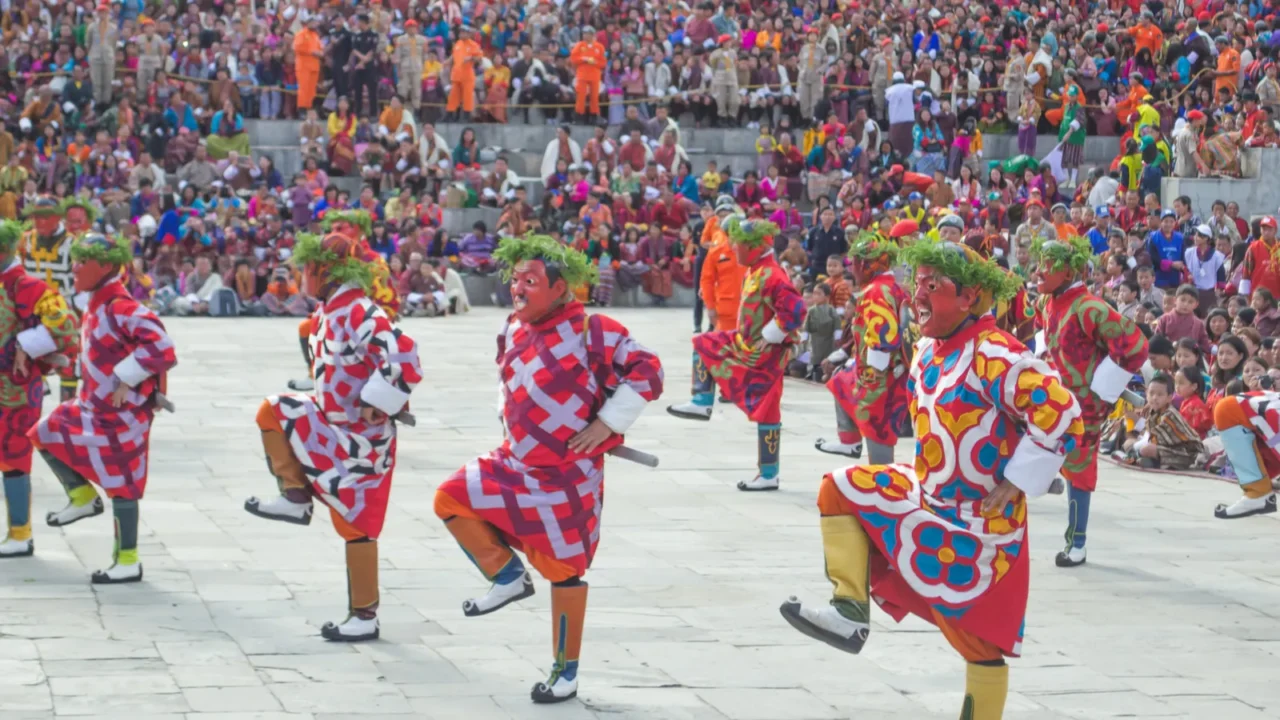bhutanese men in traditional bhutanese dress gho performing cham dance