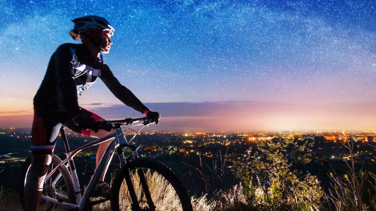 bicyclist with mountain bike on top of the hill