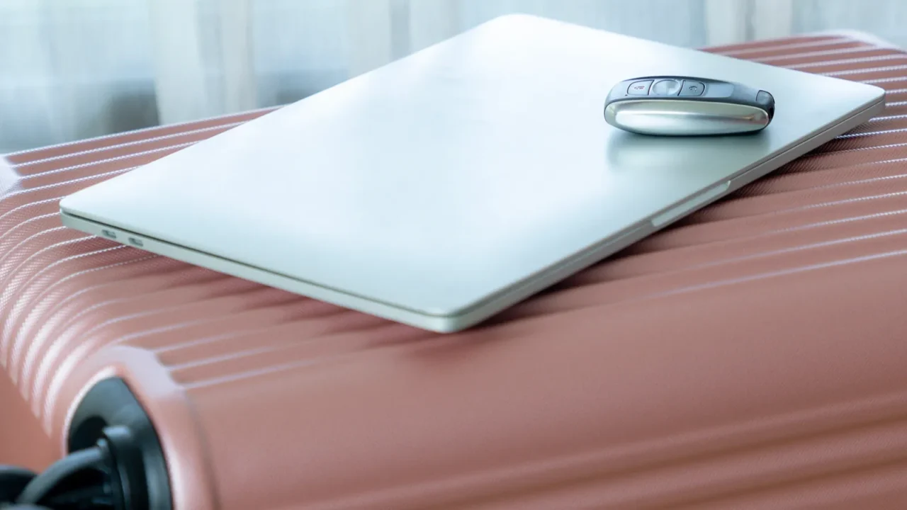 car keys and a laptop are placed on top of