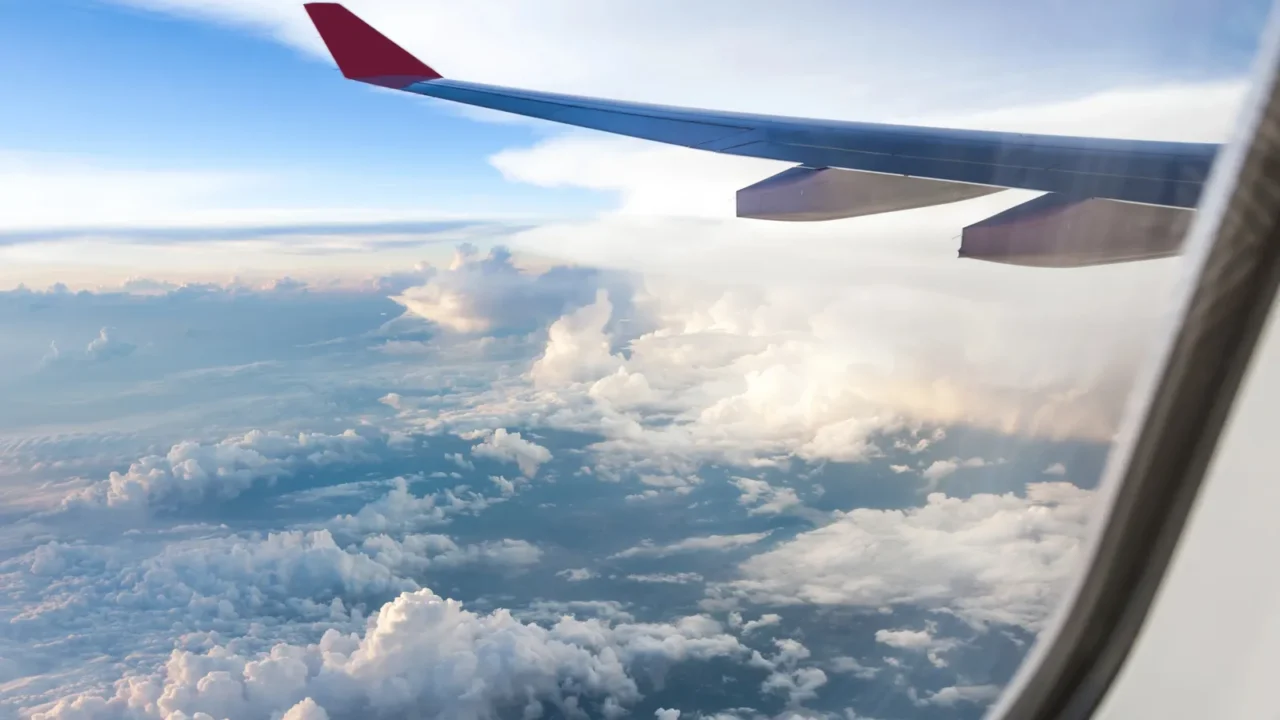 clouds and sky as seen through window of an aircraft
