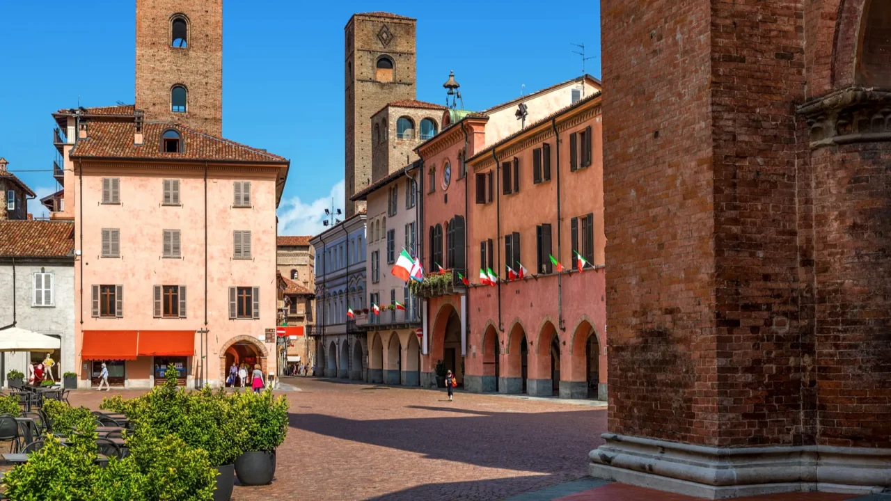 cobblestone square surrounded by historic houses and medieval towers in