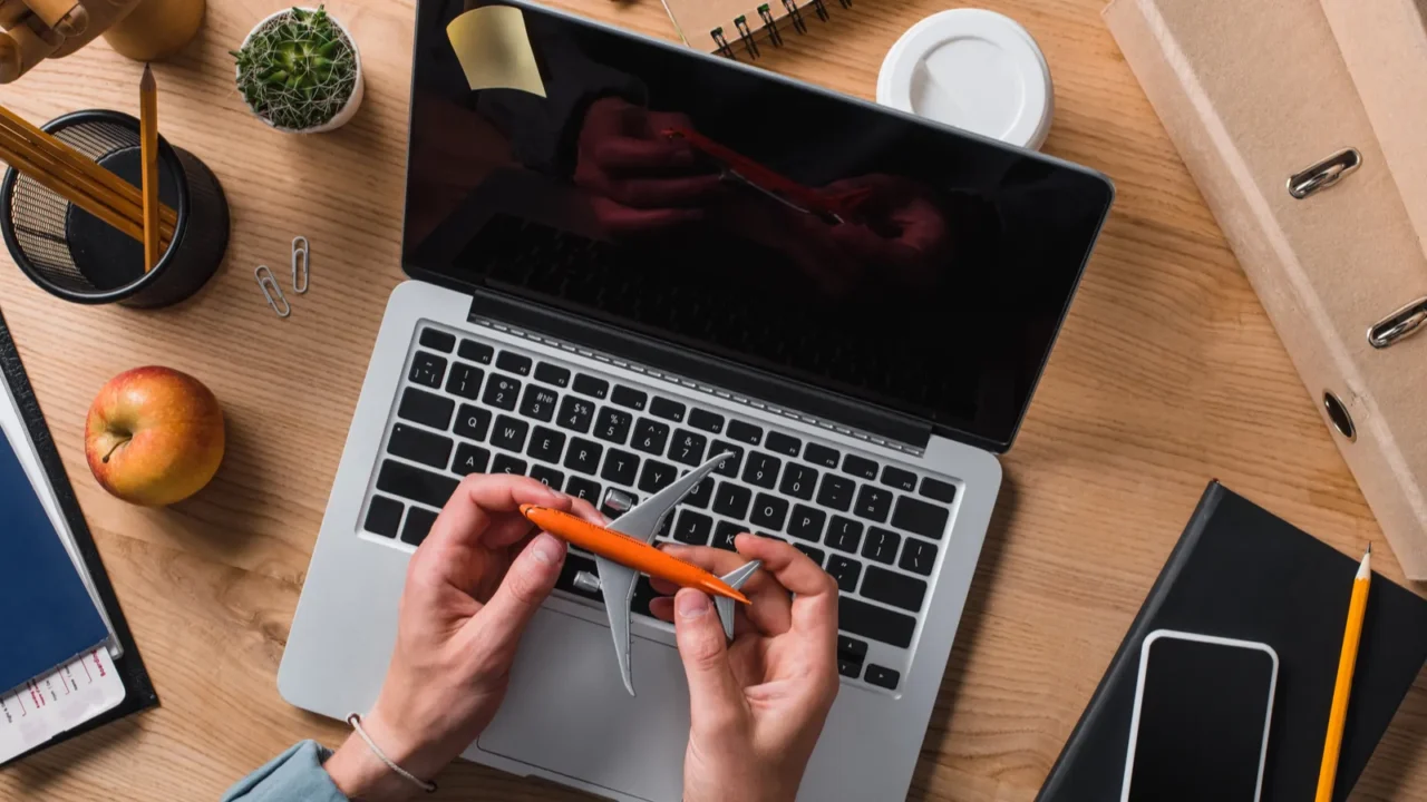 cropped shot of businessman holding toy airplane at workplace