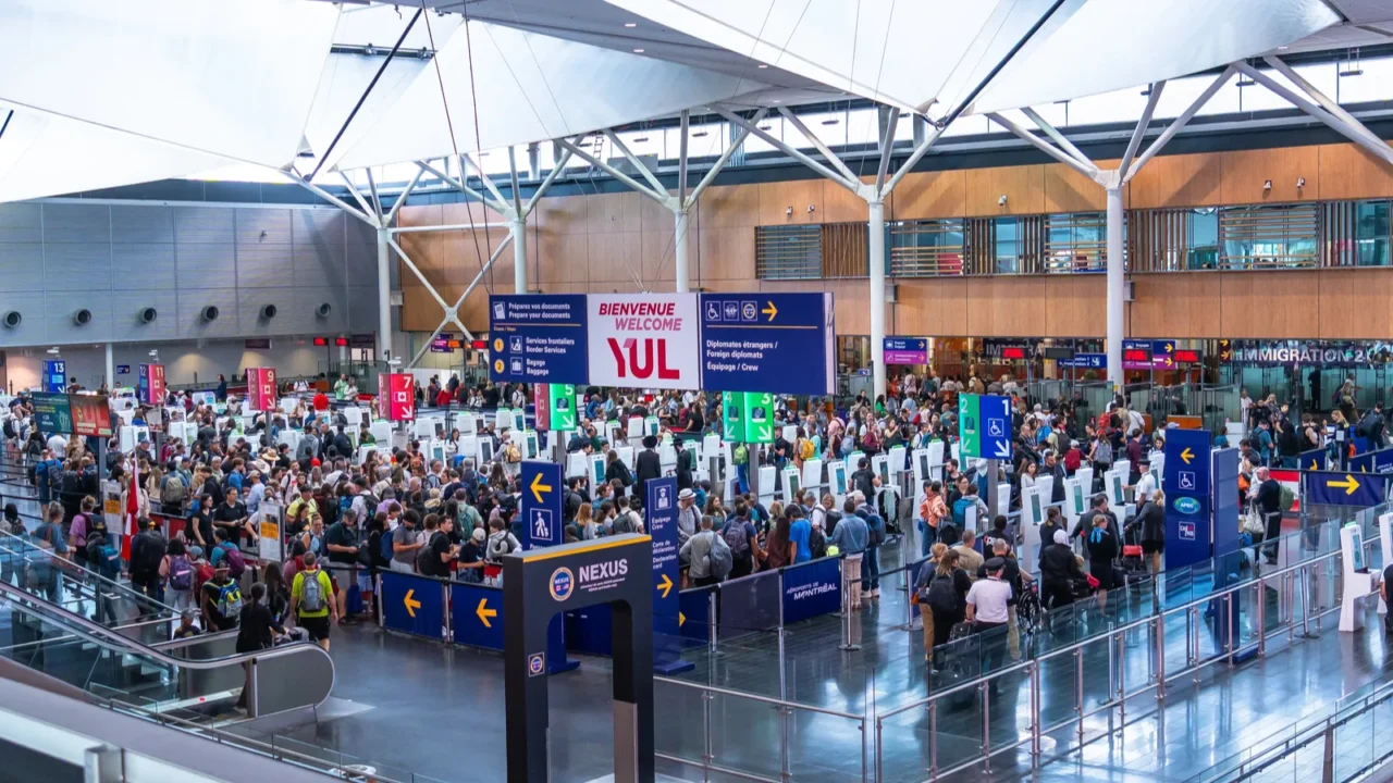 crowds of international passengers navigating immigration control at pierre elliott