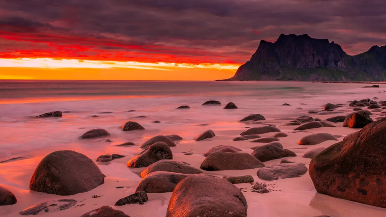 dramatic midnight sunset with amazing colors over uttakleiv beach on