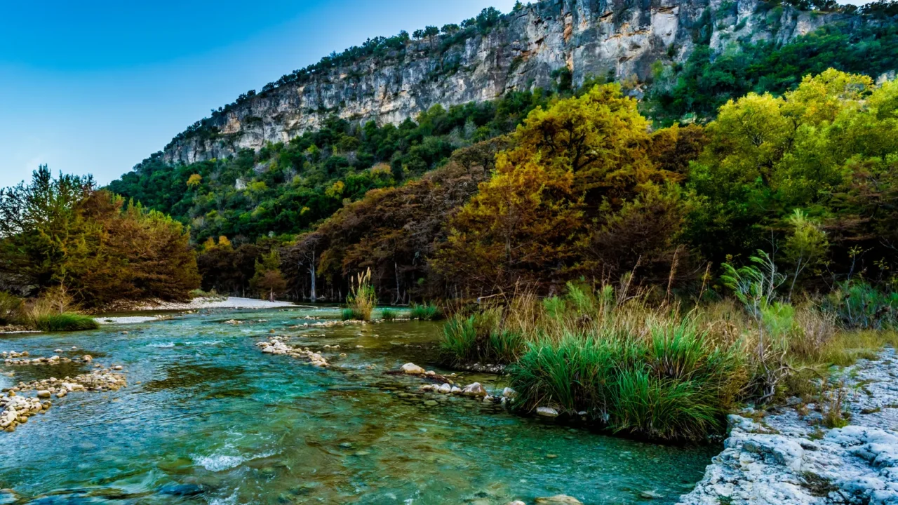 fall foliage on the crystal clear frio river in texas