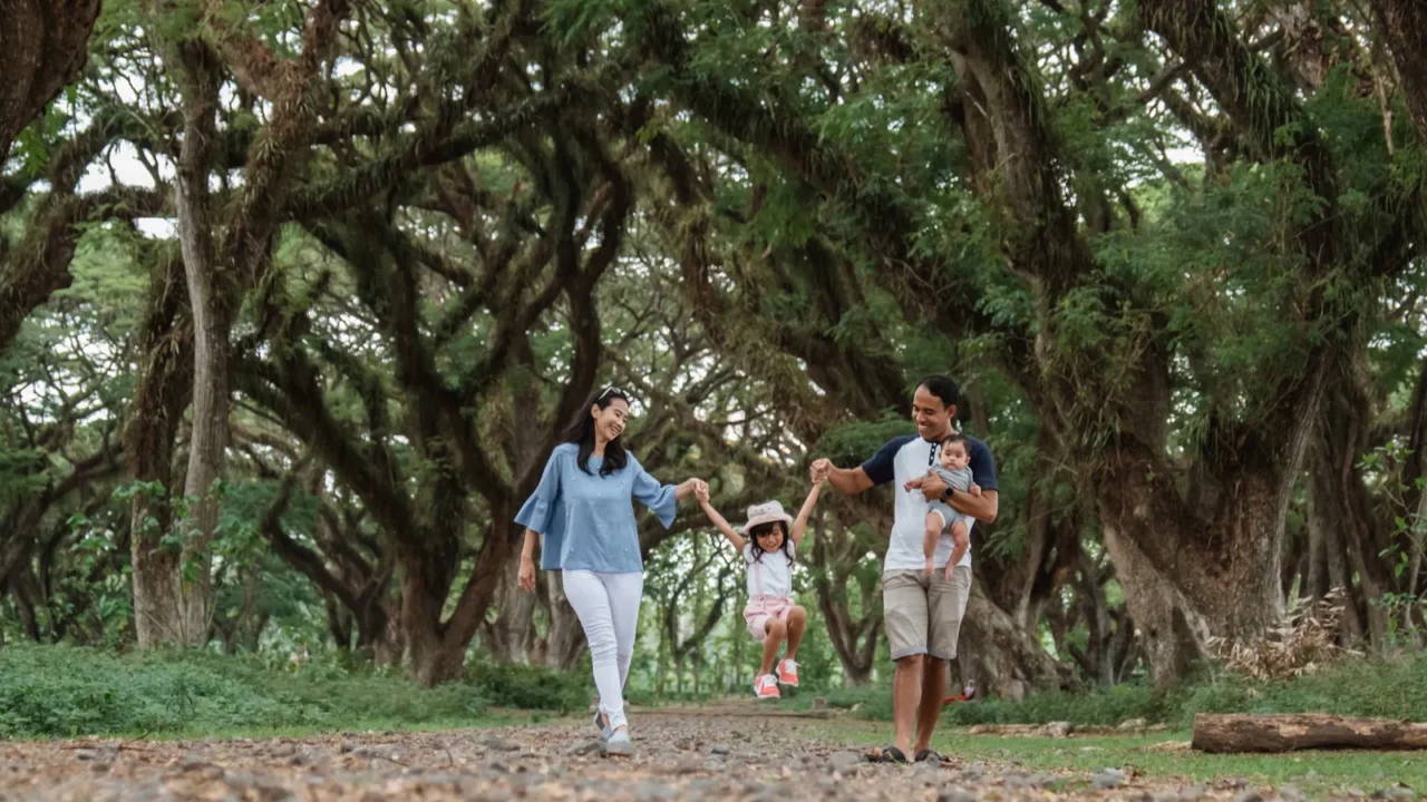 father mother and two children walking together