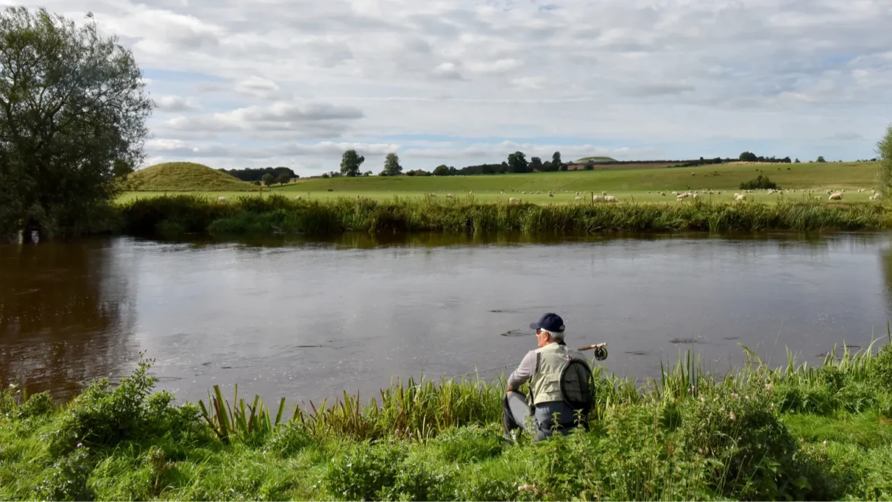 fisherman waiting on riverbank