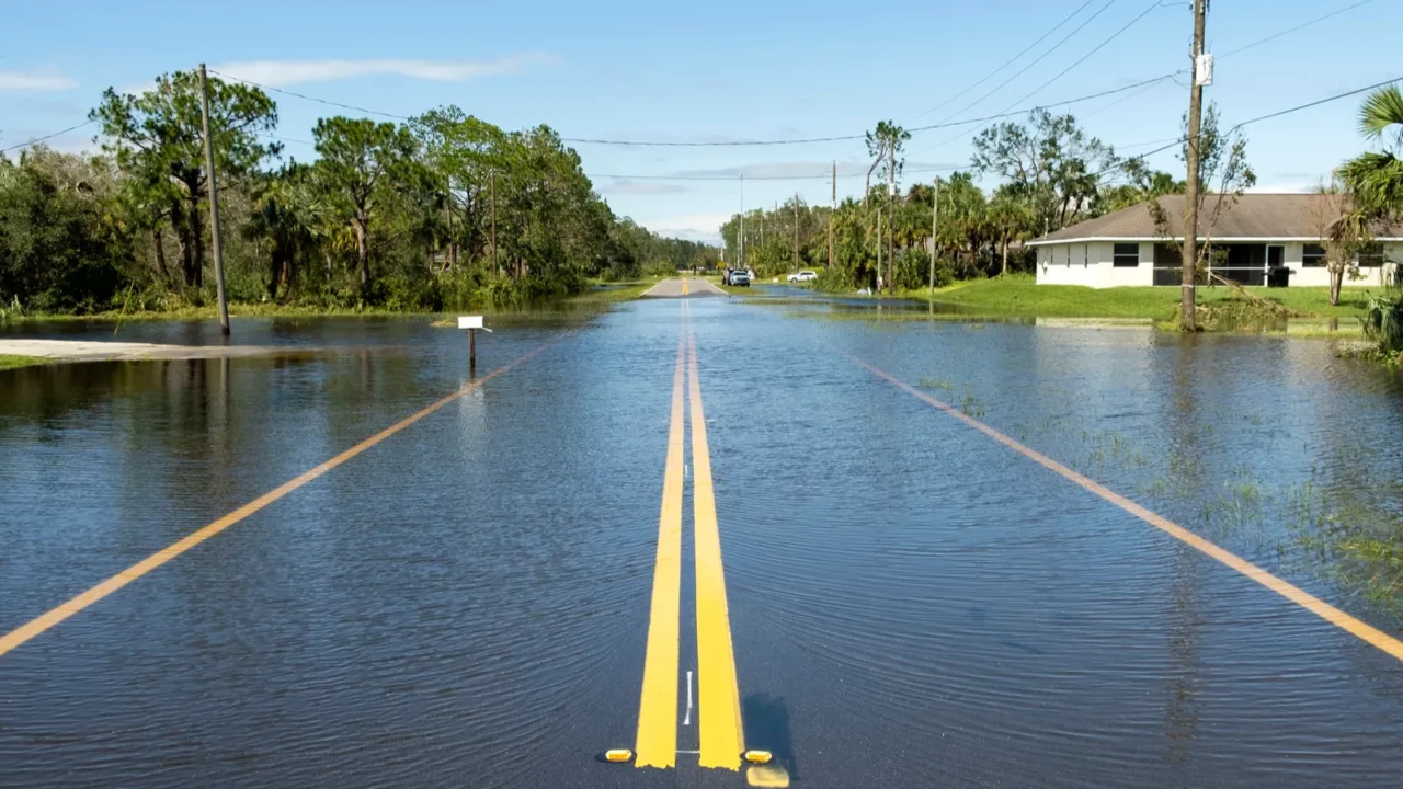 flooded american street in florida residential area hazardous driving conditions