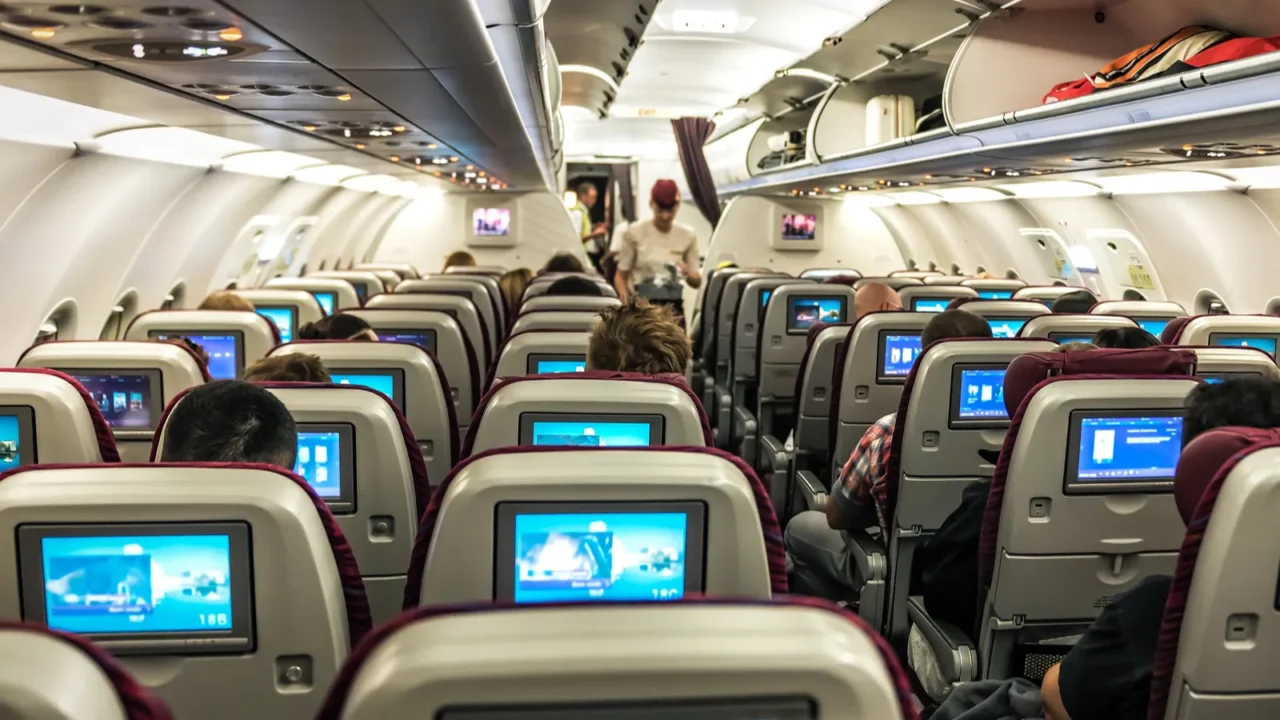 full cabin of a passenger plane chairs with screen