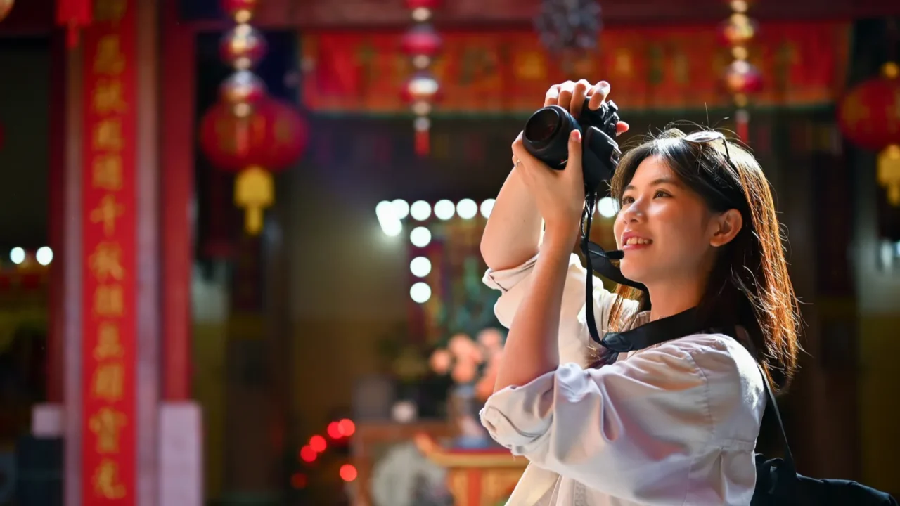 happy and joyful young female tourist enjoys taking photos in