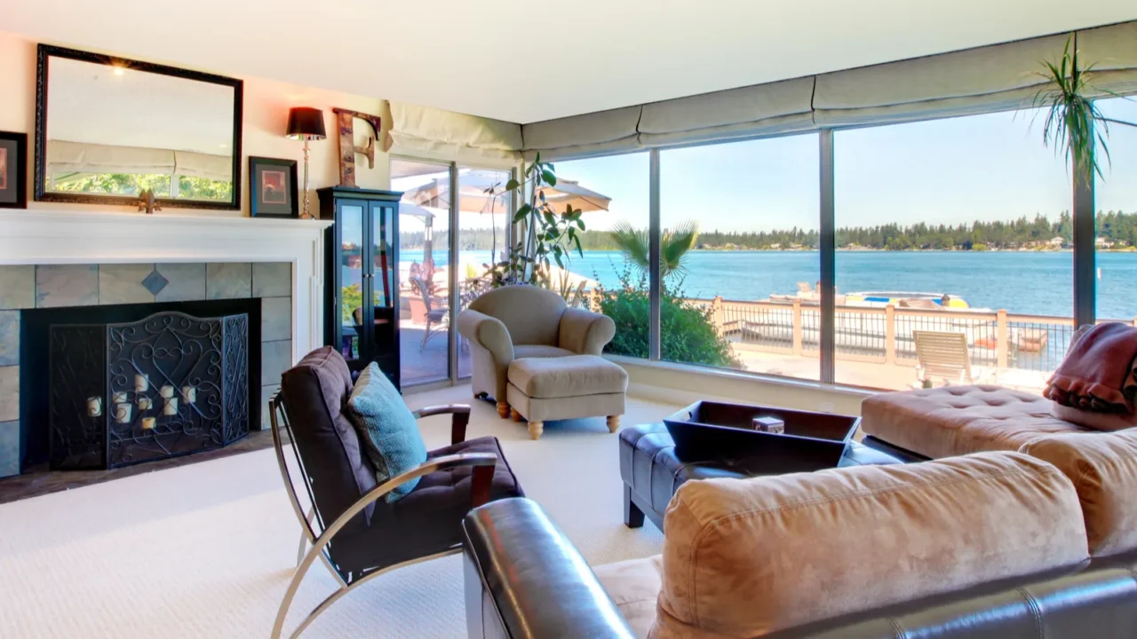 living room with fireplace and water view with large windows