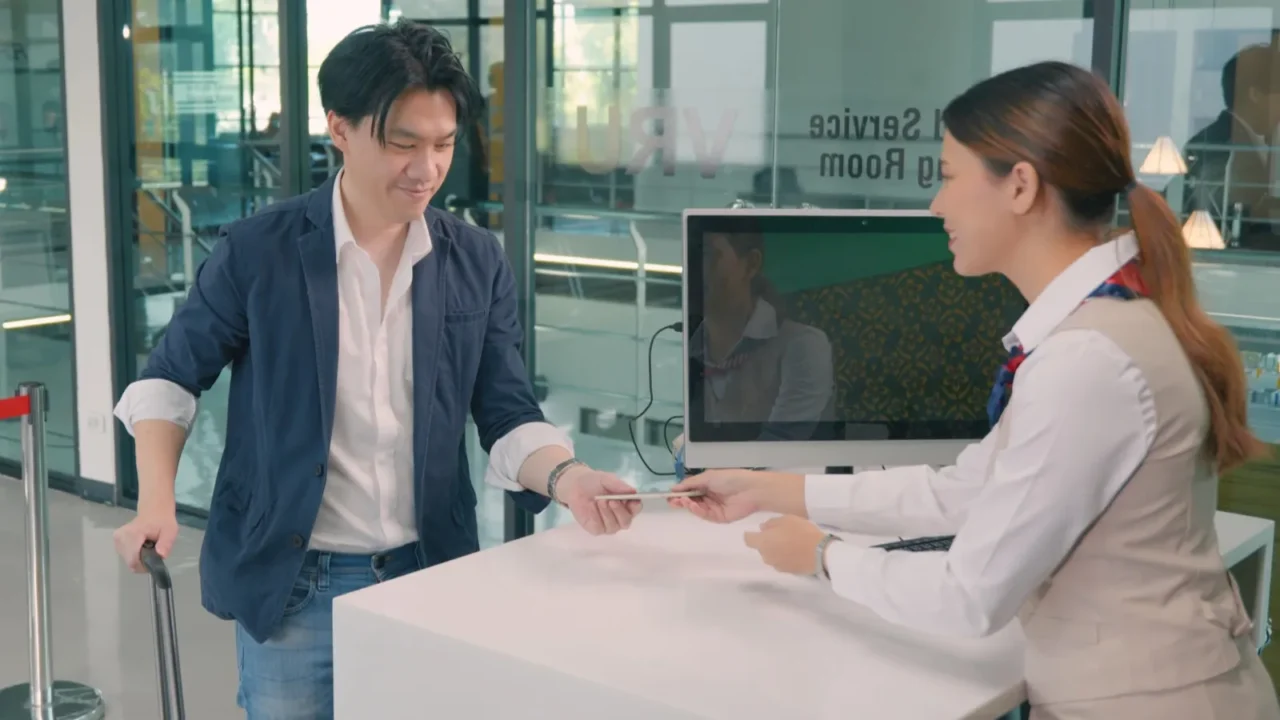 male tourist in international airport at checkin counter checking staff