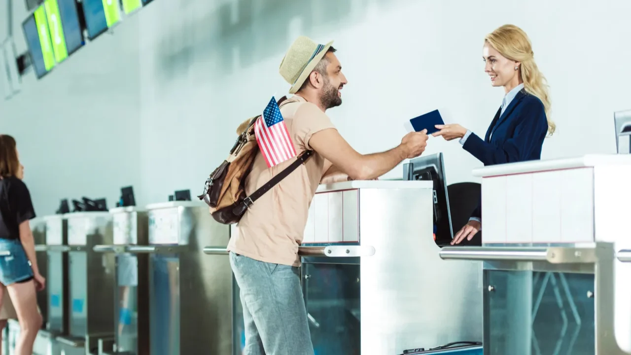 man at check in desk at airport