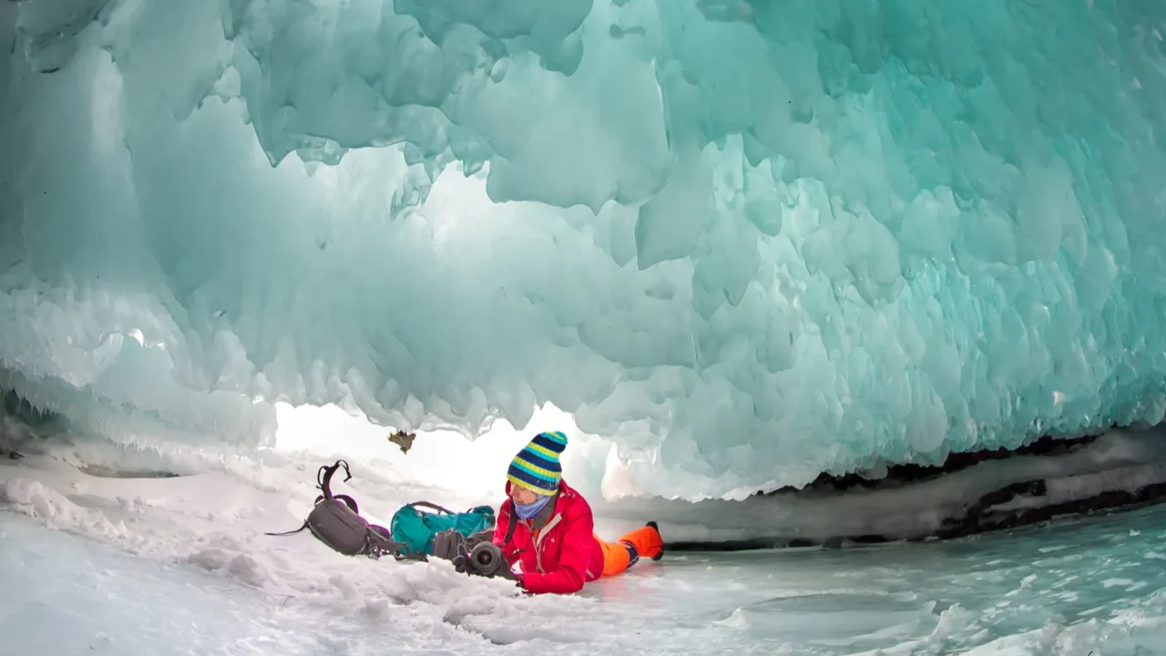 man between the ice rocks on lake baikal on a