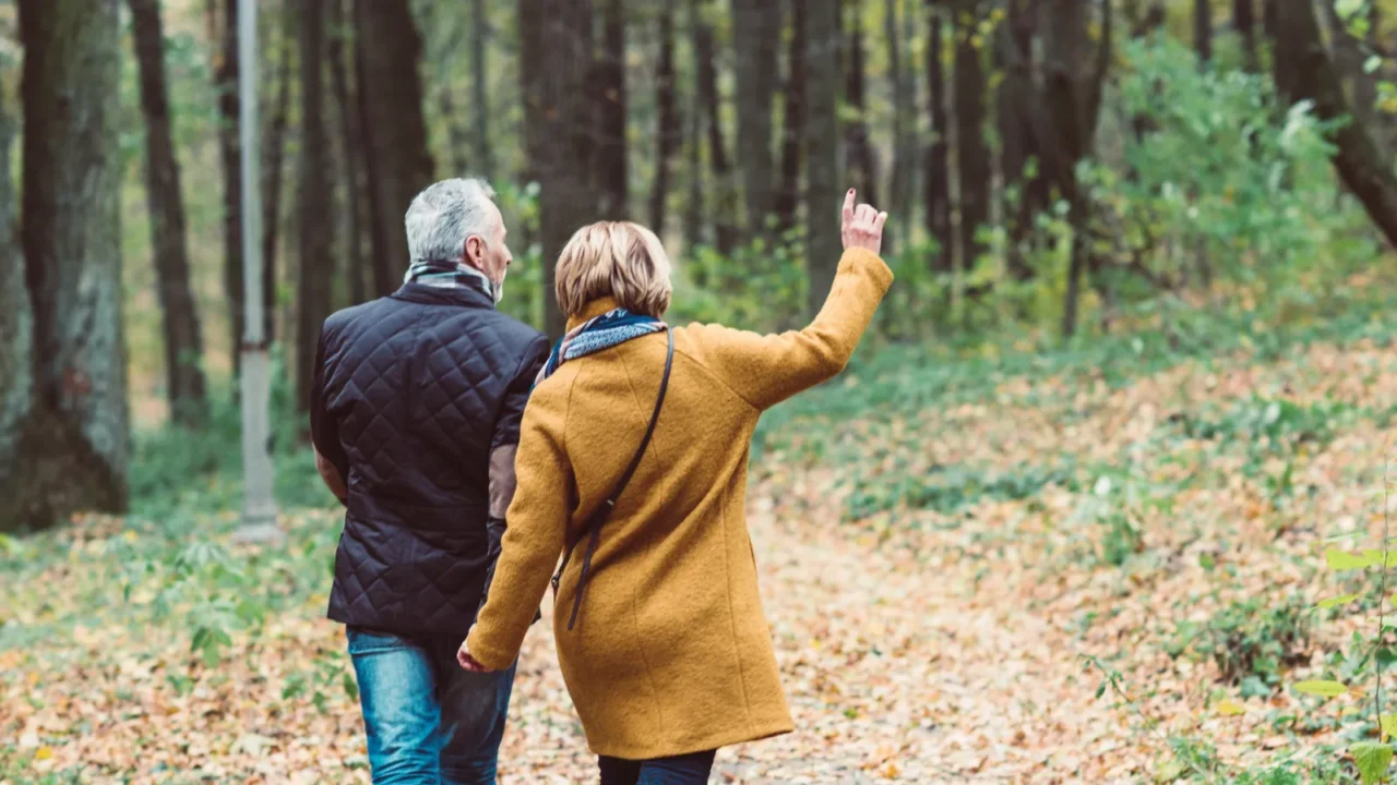 mature couple walking in autumn park