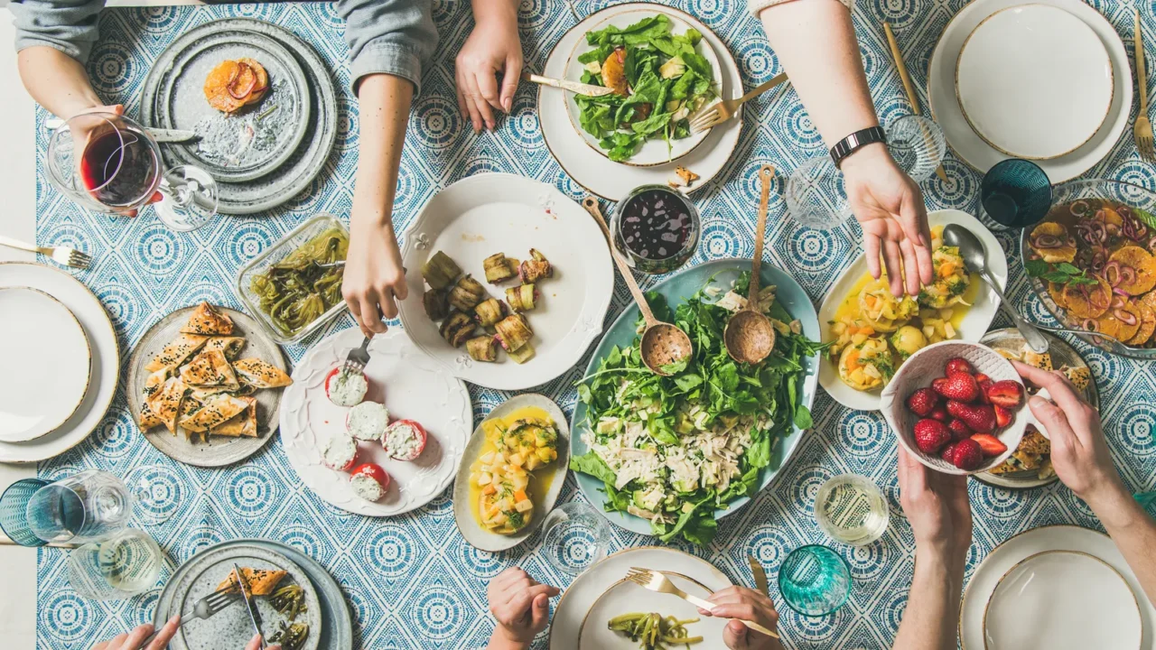 mediterranean style dinner flatlay of table with salads starters pastries