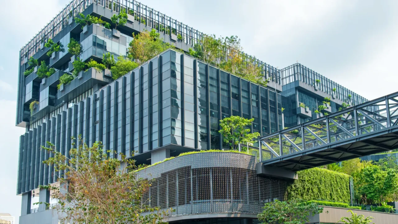 modern ecofriendly glass office building with vertical garden and skywalk