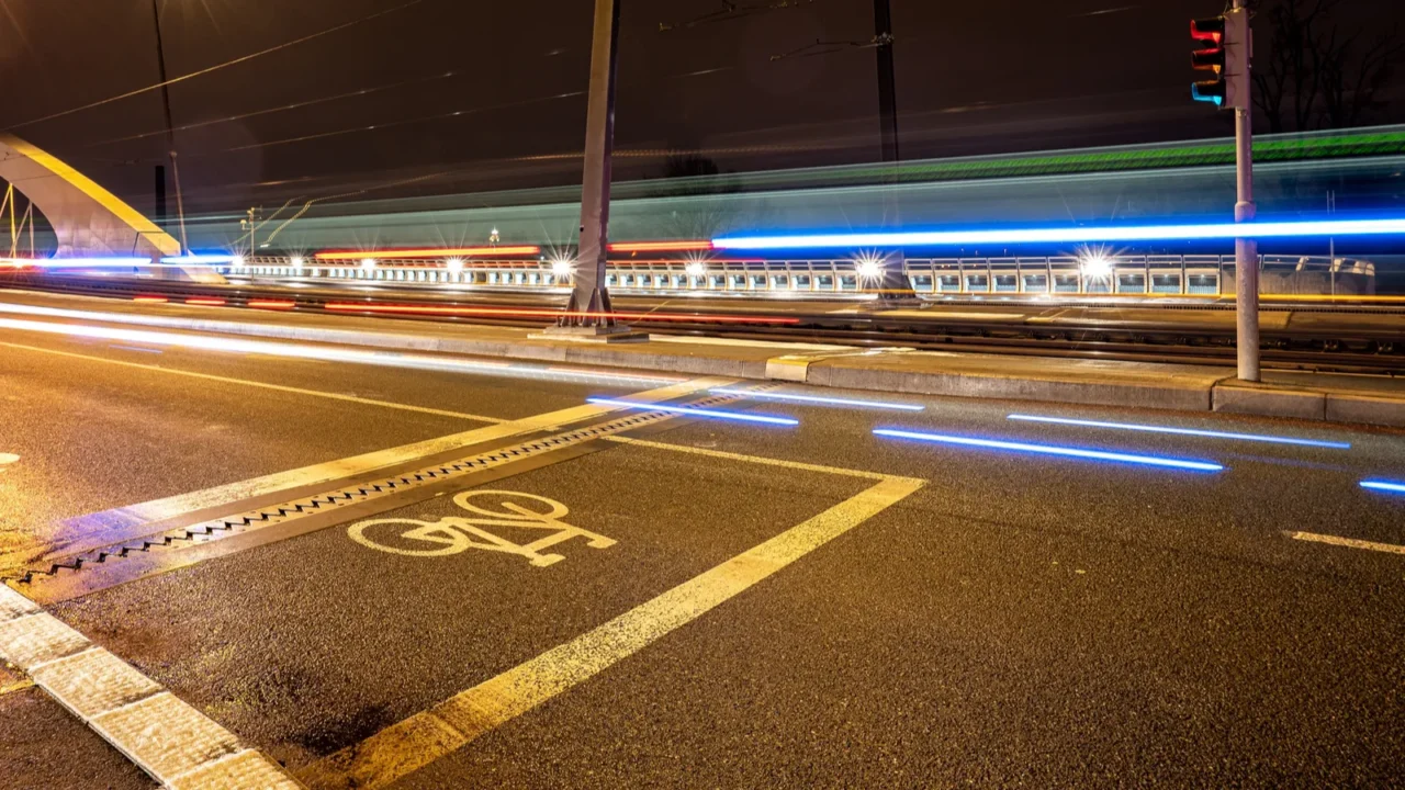 night traffic in the city with painted cycling mark on