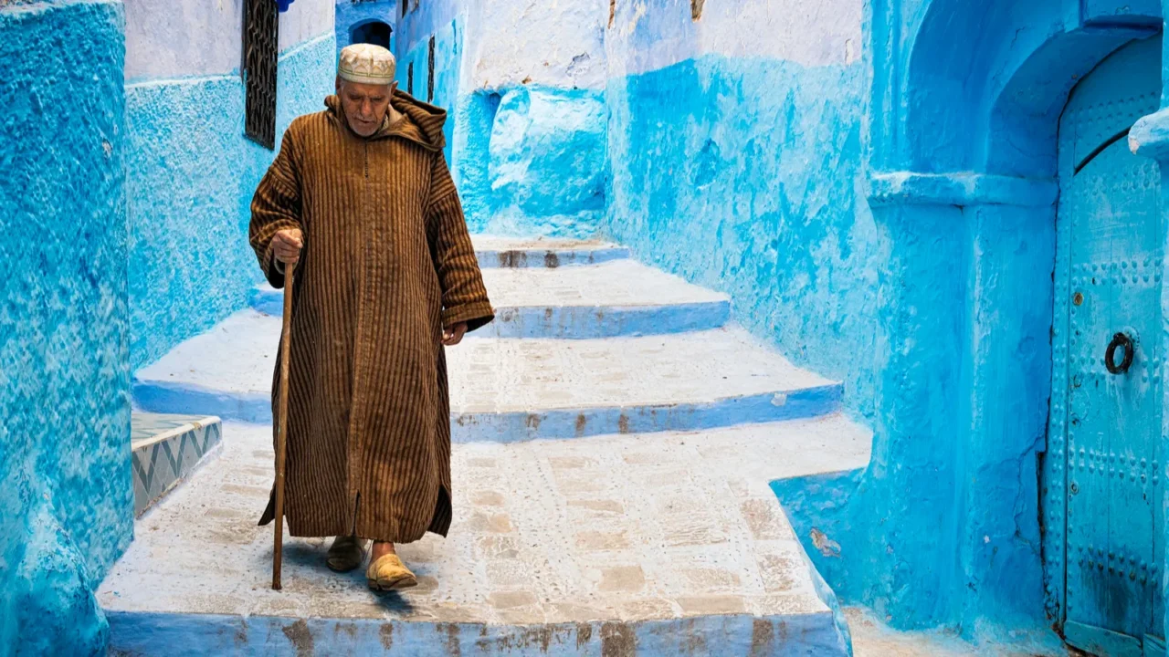 old man walking in a street of the town of